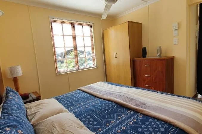 Double bedroom with blue bedding at Hopefield Garden Lodge